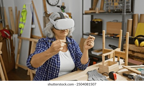 Mature woman wearing vr headset in a woodworking workshop surrounded by tools and wooden furniture pieces. - Powered by Shutterstock