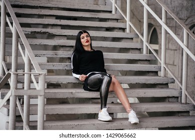 Mature women with below knee amuptation and recent osseointegration surgery sitting outside in hospital grounds enjoying the sunshine before starting walking therapy with a new prosthetic attachment. - Powered by Shutterstock