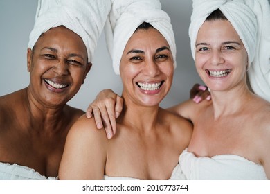 Mature Women Laughing Together While Wearing Body Towels - Main Focus On African Female Face