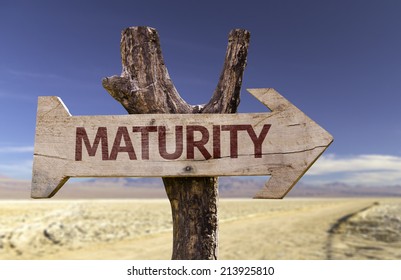 Maturity wooden sign with a desert background 