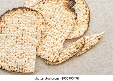 Matzah for Jewish holiday Pesach on rustic background.