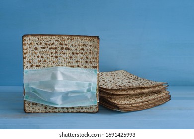 Matzah for Pesach in medical mask. Pesach celebration concept during the Covid-19 epidemic and quarantine.