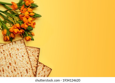 Matzo And Flowers On Yellow Background, Top View. Passover (Pesach) Seder Pesach Celebration Concept (jewish Passover Holiday).