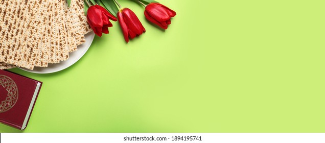 Matzos, Torah and flowers on green background, flat lay with space for text. Passover (Pesach) Seder