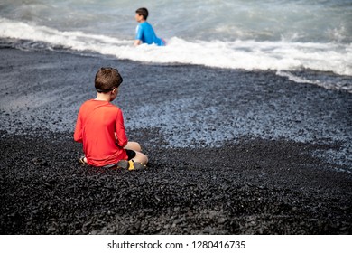 Maui Black Sand Beach Son Child Admiring The View And Skipping Pebbles