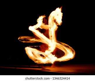 Maui, Hawaii, United States - April 26, 2006: Luau Fire Dancer At Night With A Flaming Dragon