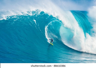 MAUI, HI - MARCH 13: Professional surfer Carlos Burle rides a giant wave at the legendary big wave surf break "Jaws" during one the largest swells of the winter March 13, 2011 in Maui, HI.