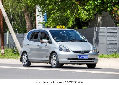 Maun, Botswana - February 9, 2020: Silver Taxi Car Honda Fit In The Town Street.