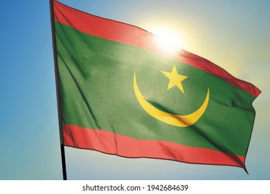 Mauritania Flag Waving On The Wind In Front Of Sun