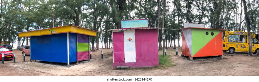MAURITIUS - MAY 2, 2019: Colorful huts selling food on the beach, panoramic view. They are typical on the island.