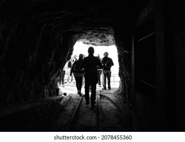 Mausa, Italy - CIRCA July 2019: A group of tourists exit from Porto Flavia mine