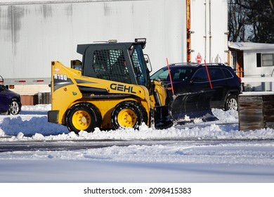 Mauston, Wisconsin USA - December 20th, 2021: GEHL Track And Skid Loader Being Used To Plow Snow. 