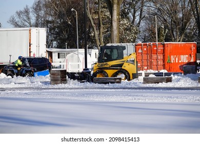 Mauston, Wisconsin USA - December 20th, 2021: GEHL Track And Skid Loader Being Used To Plow Snow. 