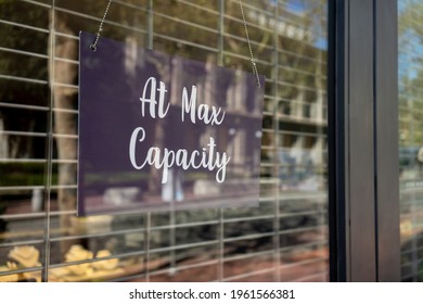 At Max Capacity sign at the entrance to a retail store when maximum occupancy is reached during the coronavirus pandemic. - Shutterstock ID 1961566381