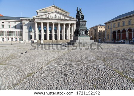 The Max Joseph Monument at the Max Joseph Square in Munich Germany with the Bavarian State Opera in the background