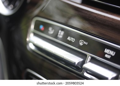 Maximum windscreen heat and other ventilation buttons on the dashboard of a luxury vehicle