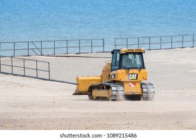 May 1 2018 Warren Dunes State Par Bridgman MI USA; Beach Clean Up With A Bulldozer Helps Move Sand Back To The Beach Where It Belongs