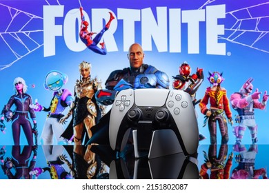 May 1, 2022, Odessa, Ukraine. White new Playstation 5 gamepad on the background of the game fortnite. Fortnite cybersport poster concept.