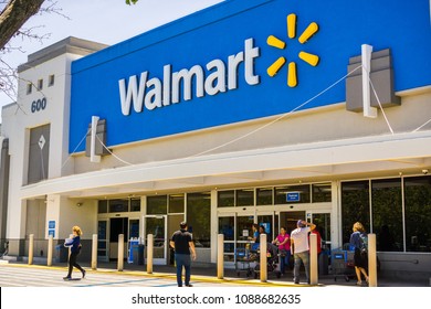 May 11, 2018 Mountain View / CA/ USA - People going in and coming out of a Walmart store on a sunny day, south San Francisco bay area 