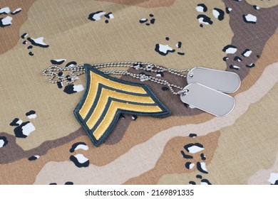 May 12, 2018. US ARMY Sergeant Rank Patch And Dog Tags On Desert Camouflage Uniform
