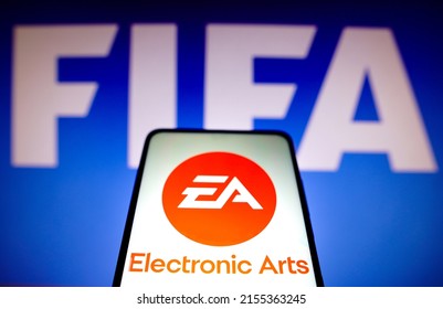 May 12, 2022, Brazil. In this photo illustration, the Electronic Arts Inc. (EA) logo seen displayed on a smartphone screen and in the background, the FIFA logo