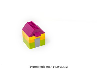 May 15, 2019 - Rome, Italy - Lego House Made Of Classic Colored Building Blocks, Isolated On White. Concept Of Home, Construction, Investment, Savings, Development, Family, Real Estate.