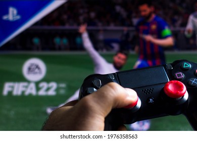 May 19, 2021, Brazil. In this photo illustration the controller for PlayStation (PS) and in the background the game logo FIFA 22