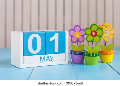 May 1st. Image Of May 1 Wooden Color Calendar On White Background With Flowers. Spring Day, Empty Space For Text.  International Workers' Day