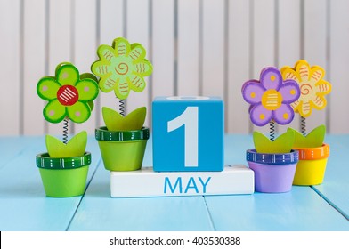 May 1st. Image Of May 1 Wooden Color Calendar On White Background With Flowers. Spring Day, Empty Space For Text.  International Workers' Day