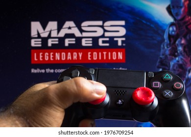 May 20, 2021, Brazil. In This Photo Illustration The Controller For PlayStation (PS) And In The Background The Game Logo Mass Effect: Legendary Edition