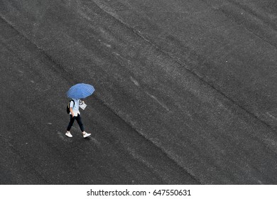 May 2017 - Guangzhou, China. A Student Walks Under The Rain At Guangdong University In Guangzhou.