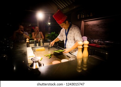 May, 2018 - Ari Atoll, Maldives: Happy Teppanyaki Chef Cooking Vegetables At Teppan In A Japanese Steakhouse On Mishi Sushi. Gourmet Food In Luxury Restaurant. 