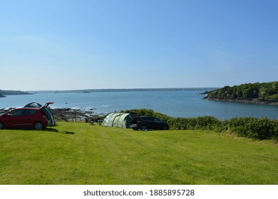 May 2018, Pembrokeshire, Wales, UK. A View On The Sea From The Camping Site With Tents And Cars. 