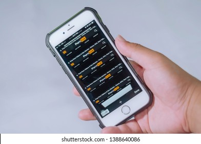 May 2019 - Manila, Philippines - Man hand holding a smartphone with multiple open tabs of PornHub website on the internet browser isolated on a white background. Holding a smartphone with porn sites.