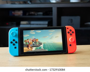 May 2020, UK: Nintendo Switch Games Console In Home With Animal Crossing New Horizons Game