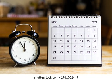 May 2021 Calendar - Month Page Showing Date And Vintage Clock On Wooden Table