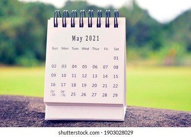 May 2021 white calendar with green blurred background. 2021 new year concept