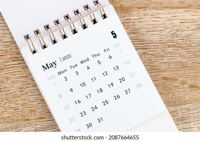 The May 2022 desk calendar on wooden table. - Shutterstock ID 2087664655