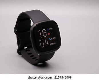 May 2022, UK: Fitbit Versa 3 Fitness Tracker Band In Black With Heart Rate, Step Count And Clock Face Display Turned On