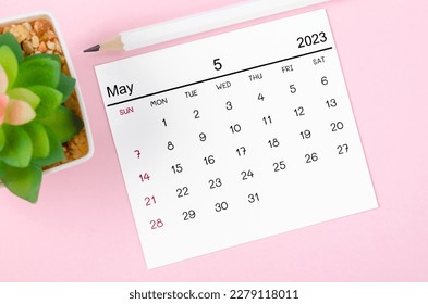 May 2023 Monthly calendar for 2023 with wooden pencil year on pink background.