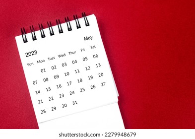 May 2023 Monthly desk calendar for 2023 year on red background.