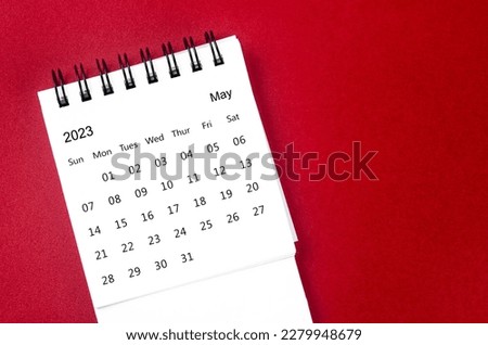 May 2023 Monthly desk calendar for 2023 year on red background.