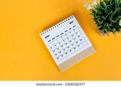 May 2024 desk calendar on yellow background. Directly above. Flat lay. Copy space.