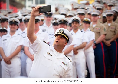 MAY 22 2019-NEW YORK: A U.S. Navy Officer Takes A Cellphone Selfie With Sailors And Marines On The Red Steps In Father Duffy Square For Fleet Week In Manhattan On May 22, 2019.