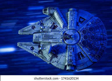 MAY 23 2020: scene from Star Wars - Corellian freighter Millennium Falcon travels through Hyperspace - Kessel Run - X-Wing miniature game ship