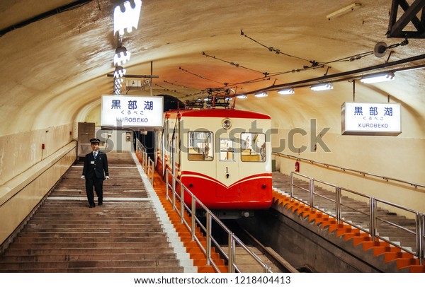 MAY 28, 2013 Toyama, Japan - Passenger and\
station officer at Korobeko tunnel with Kurobe Cable Car of Kurobe\
Dam, only underground cable car in\
Japan