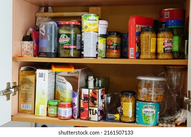May 28, 2022, Moscow, Russia: typical Russian foodstuffs and utensils stand in disarray on a shelf in a cupboard