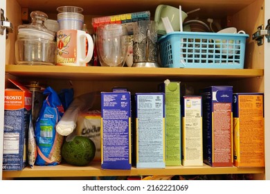 May 28, 2022, Moscow, Russia: typical Russian foodstuffs and utensils stand in disarray on a shelf in a cupboard