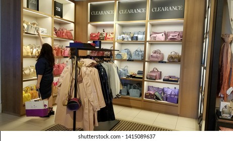 May 30,2019, Coach store, Outlet Waipahu, Hawaii : Shopping woman in Coach store, she looking to buy the bags at because the prices very cheap.