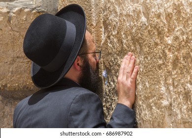 May 31, 2017. Orthodox Jewish man praying inside the synagogue at the Western Wall (Wailing Wall) in Jewish Quarter, Old City, Jerusalem, Israel.